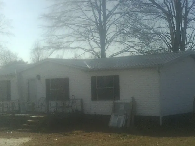 New metal roof on a white painted brick home on a foggy morning in Garwood